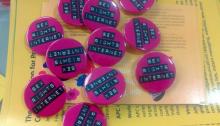 Round pink badges with black and white text titled 'Sex Rights Internet' on a yellow background